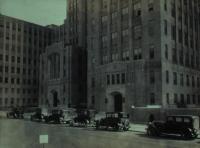 Old picture of 168th street with cars and tall buildings