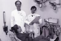 Steven Roser is standing in the lest of the photo with an assistant dentist. He is going to examine a patient