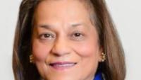 Headshot of a woman in a bright blue blazer.