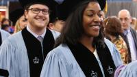 Dental students smile at commencement.