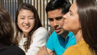 diverse group of students sitting together and talking