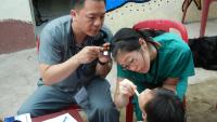 dentists performing an exam in developing country