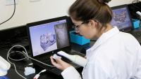 female student in computer lab working with dental software