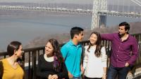 Students talk near the Hudson River and Columbia's campus.