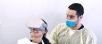 Patient uses virtual reality headset in Columbia University College of Dental Medicine clinic.