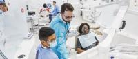 Dental providers with patient in clinic