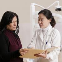 Dentist explaining chart to a patient in a clinic